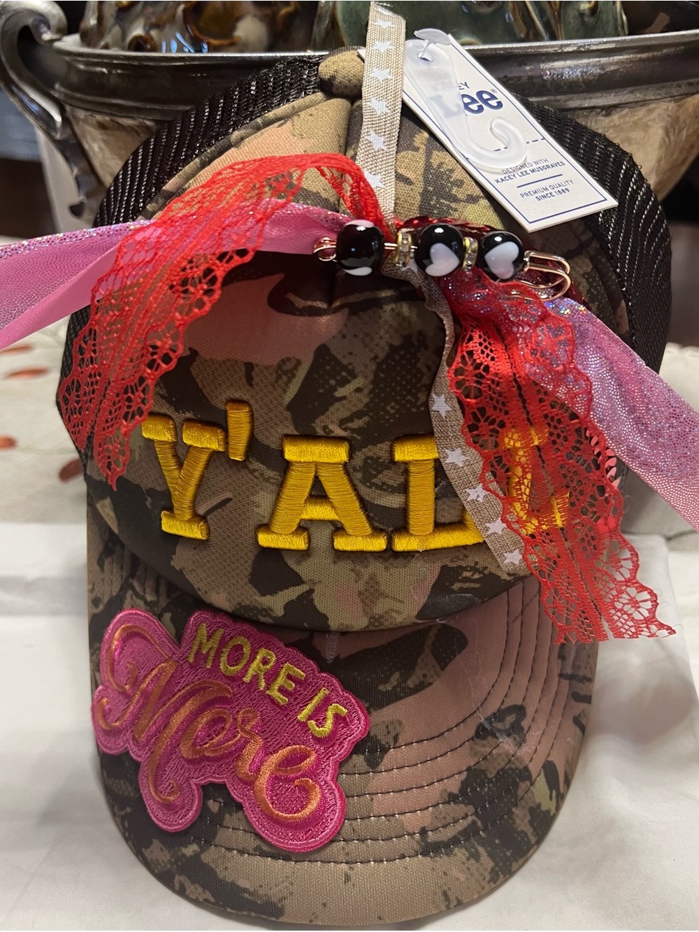 Camouflage 'Y' Ball Cap with Pink 'More Is More' Patch and Red Ribbon Accents